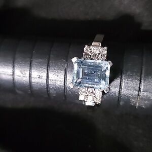 14 carat white gold setting with aqua marine Center and Diamond sides  Size 8